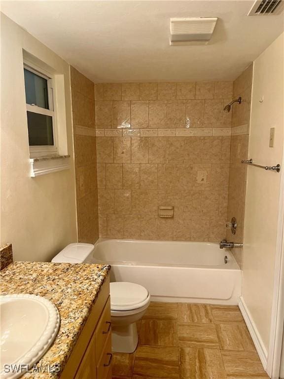 full bathroom featuring vanity, toilet, and tiled shower / bath combo