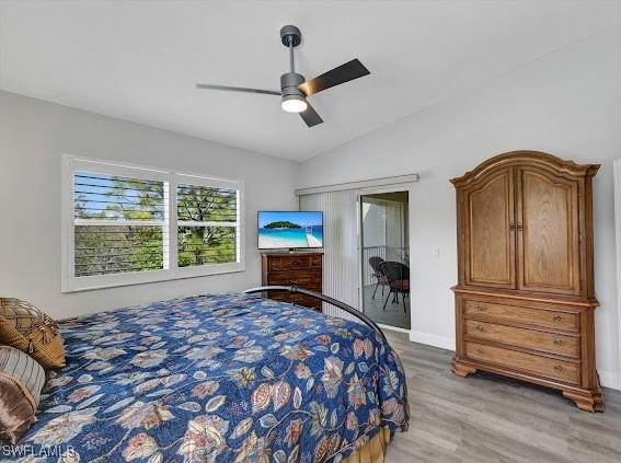 bedroom featuring ceiling fan, lofted ceiling, access to exterior, and light wood-type flooring