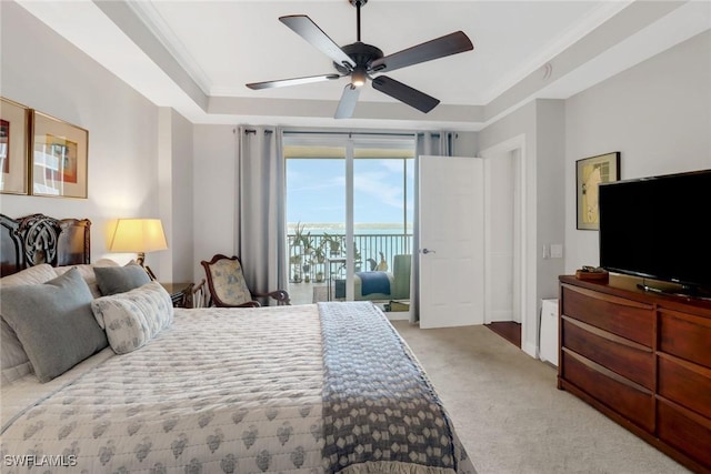 carpeted bedroom with access to exterior, crown molding, a raised ceiling, and ceiling fan