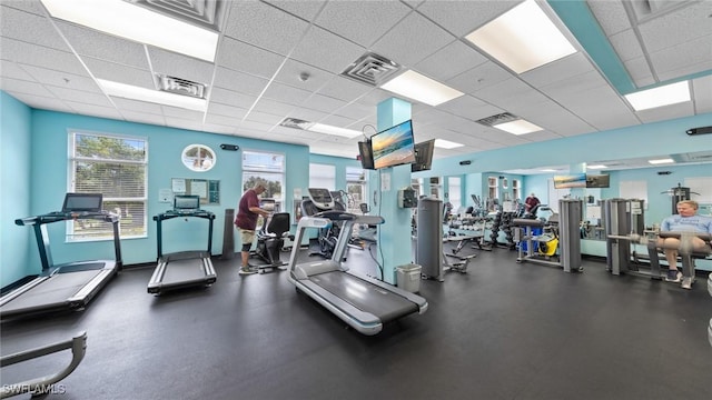 gym with a paneled ceiling
