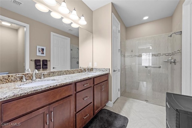 10641 Jackson Square Dr, Estero, FL 33928 - bathroom featuring double vanity, a sink, a shower stall, and visible vents