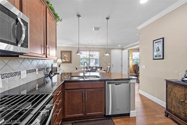 10641 Jackson Square Dr, Estero, FL 33928 - kitchen featuring visible vents, crown molding, a peninsula, appliances with stainless steel finishes, and a sink