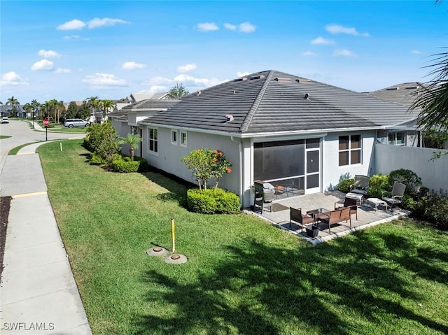 10641 Jackson Square Dr, Estero, FL 33928 - rear view of property featuring fence, a tiled roof, stucco siding, a yard, and a patio area