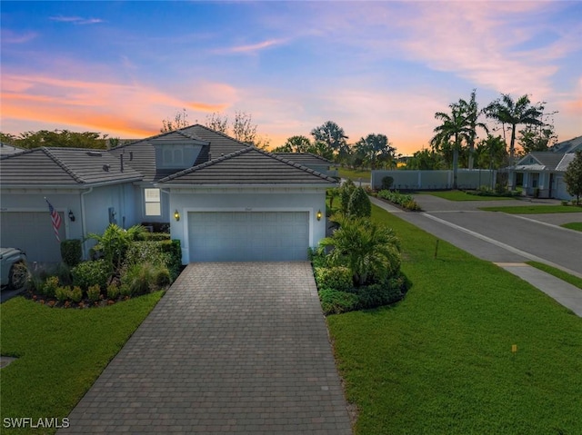 10641 Jackson Square Dr, Estero, FL 33928 - single story home with a lawn, decorative driveway, a tiled roof, and stucco siding