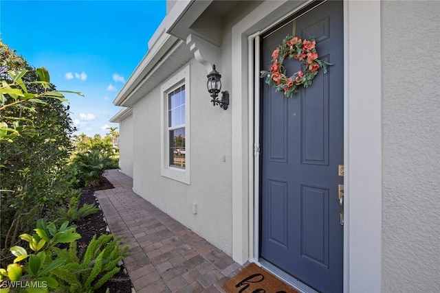 entrance to property with stucco siding