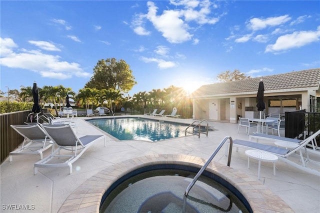 view of pool with a community hot tub and a patio area