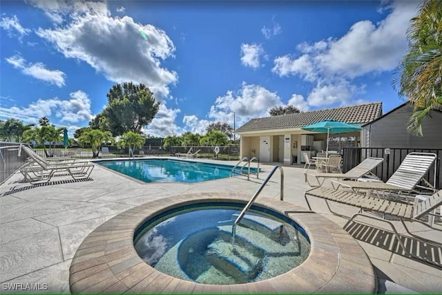 view of pool with a community hot tub and a patio area