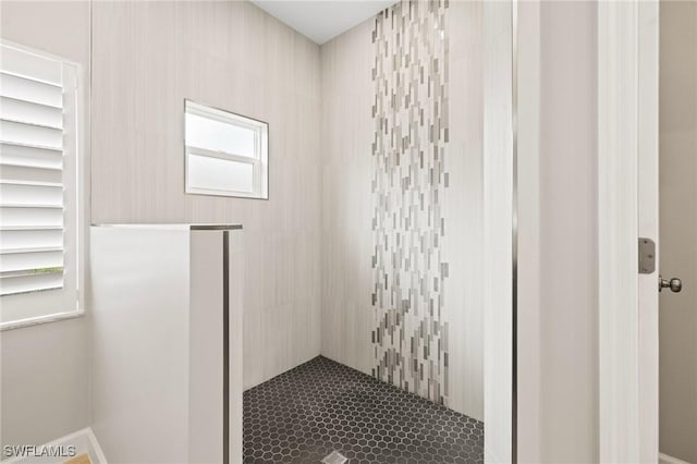 bathroom with tiled shower