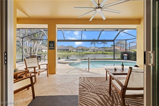 view of swimming pool featuring a lanai, a patio, a water view, and an in ground hot tub