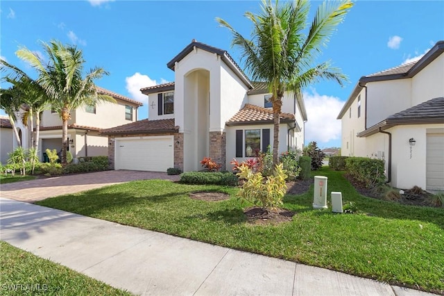 mediterranean / spanish-style home with a garage and a front yard