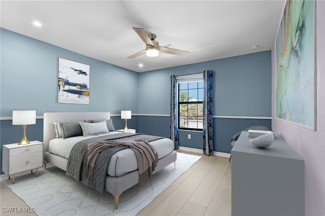 bedroom featuring light hardwood / wood-style flooring and ceiling fan