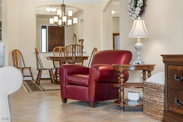 living area with a chandelier and light tile patterned floors