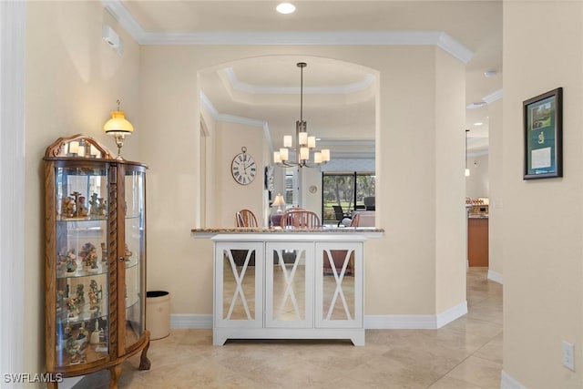 interior space with pendant lighting, light tile patterned floors, a raised ceiling, crown molding, and an inviting chandelier