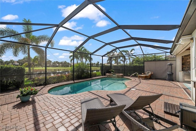 view of pool featuring an in ground hot tub, a patio, a water view, and glass enclosure