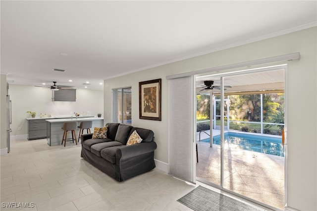 2347 Club House Rd, North Fort Myers, FL 33917 - living area featuring ceiling fan, baseboards, and crown molding