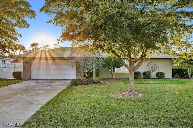 2347 Club House Rd, North Fort Myers, FL 33917 - view of front of home with a garage, driveway, fence, a front yard, and stucco siding