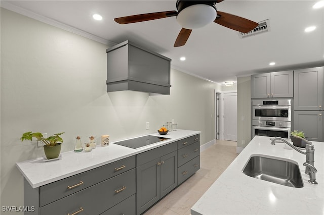 2347 Club House Rd, North Fort Myers, FL 33917 - kitchen with crown molding, a sink, stainless steel double oven, black electric stovetop, and visible vents