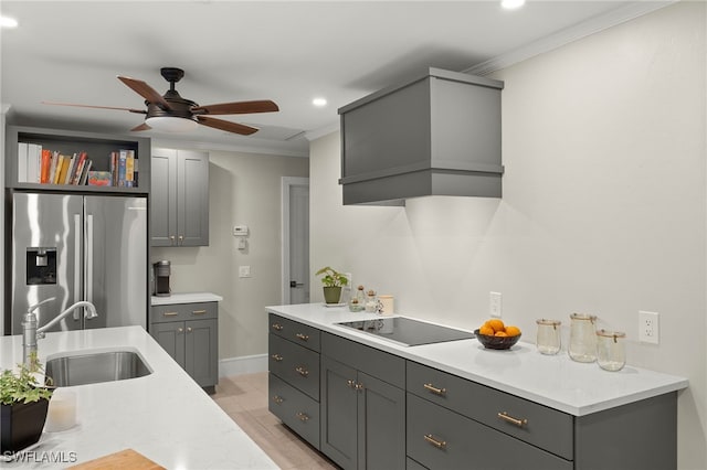 2347 Club House Rd, North Fort Myers, FL 33917 - kitchen with a sink, ceiling fan, stainless steel fridge with ice dispenser, black electric stovetop, and custom range hood