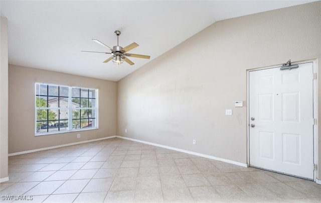 unfurnished room featuring a ceiling fan, light tile patterned flooring, vaulted ceiling, and baseboards