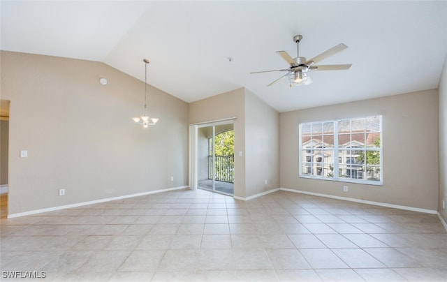 empty room featuring lofted ceiling, light tile patterned floors, ceiling fan with notable chandelier, and baseboards