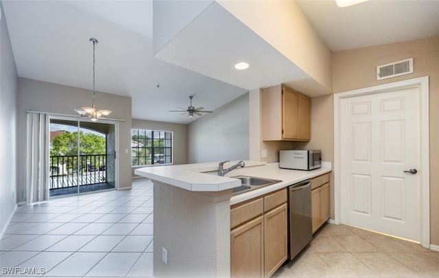 kitchen with a peninsula, stainless steel appliances, a sink, visible vents, and light countertops