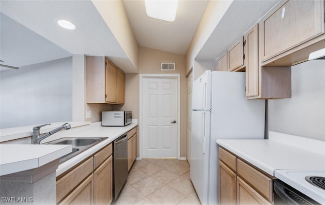 kitchen featuring stainless steel appliances, light countertops, a sink, and visible vents