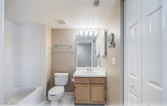 bathroom with a textured wall, toilet, tile patterned floors, vanity, and a closet