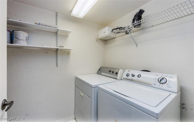 clothes washing area featuring laundry area and separate washer and dryer