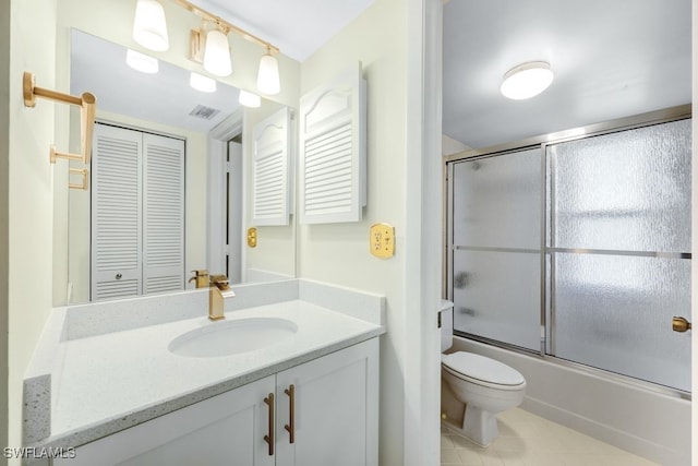 full bathroom with toilet, tile patterned floors, vanity, and shower / bath combination with glass door