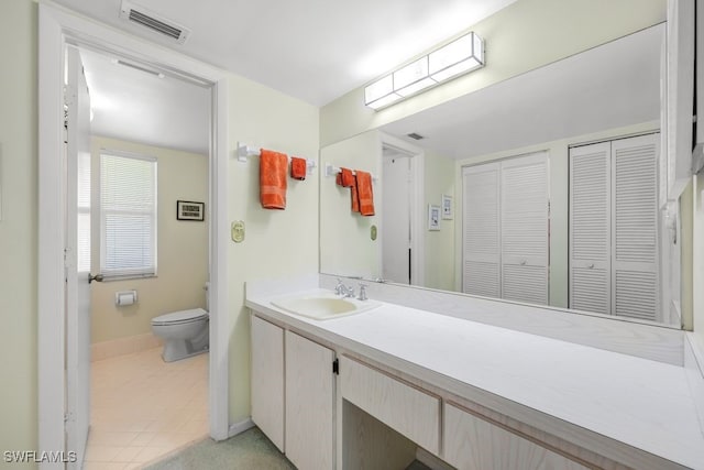 bathroom featuring vanity and toilet