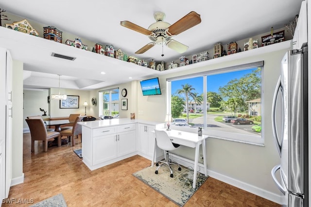 office featuring ceiling fan and a tray ceiling