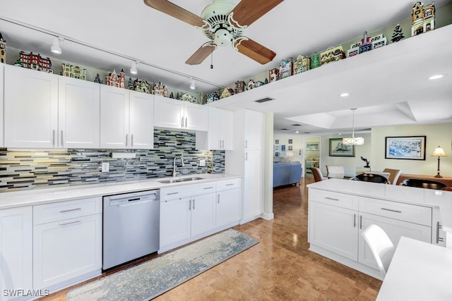 kitchen featuring white cabinetry, dishwasher, sink, backsplash, and hanging light fixtures