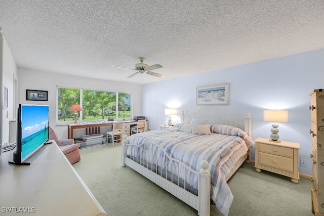 bedroom with a textured ceiling, ceiling fan, and carpet flooring