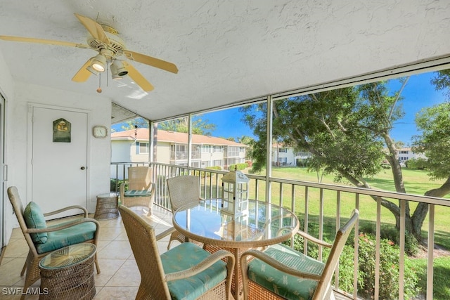 sunroom / solarium featuring ceiling fan