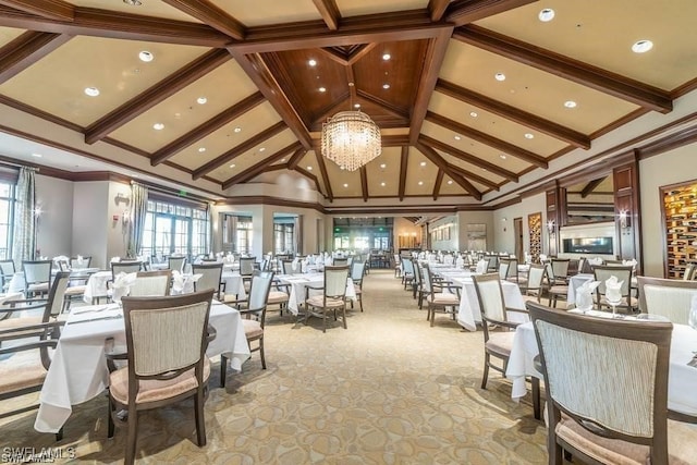 dining space with ornamental molding, beamed ceiling, and a notable chandelier