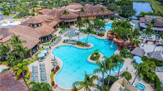 view of pool featuring a patio area and a water view