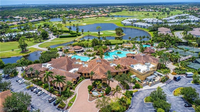 drone / aerial view featuring golf course view and a water view