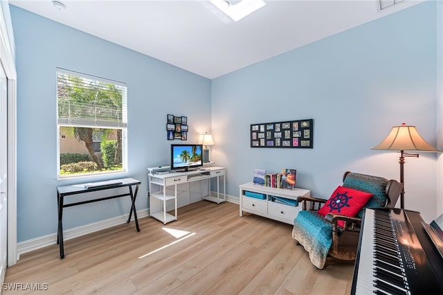 sitting room featuring light wood-style flooring and baseboards