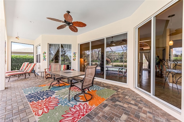 sunroom / solarium with a ceiling fan