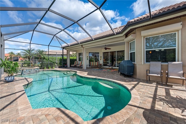 view of pool featuring a ceiling fan, area for grilling, glass enclosure, a patio area, and a pool with connected hot tub