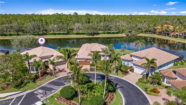 drone / aerial view with a water view and a residential view