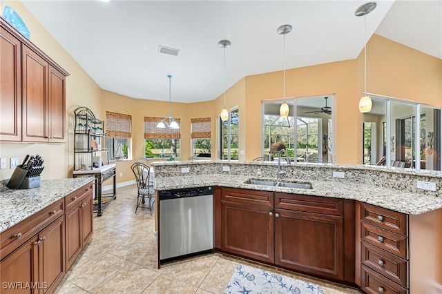 kitchen featuring visible vents, dishwasher, hanging light fixtures, light stone countertops, and a sink