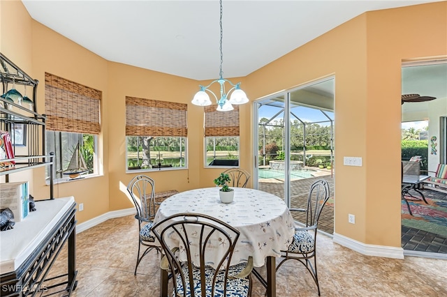 dining room with a sunroom, light tile patterned floors, baseboards, and a chandelier