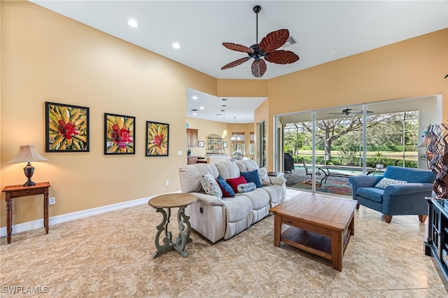 living area featuring ceiling fan, recessed lighting, a sunroom, and baseboards