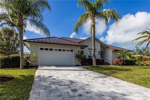 ranch-style house with a garage and a front yard