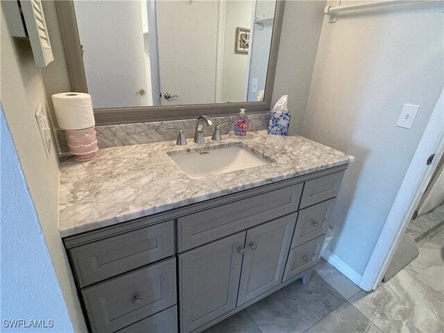 bathroom with baseboards and vanity