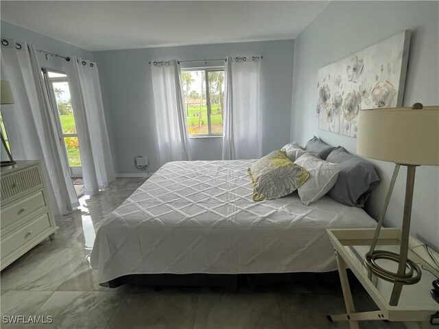 bedroom with marble finish floor and multiple windows