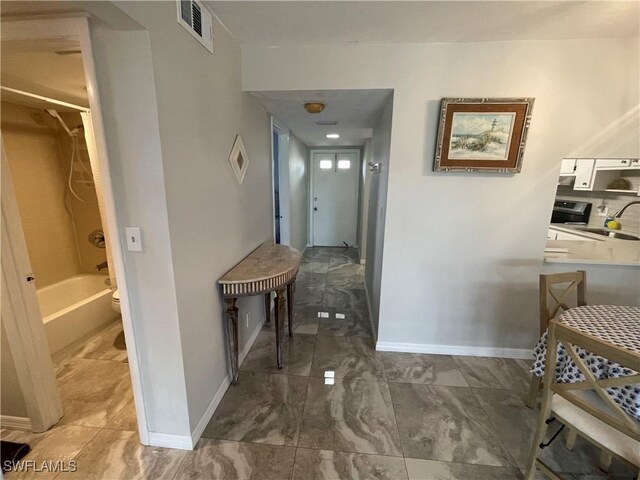 interior space featuring visible vents, marble finish floor, and baseboards