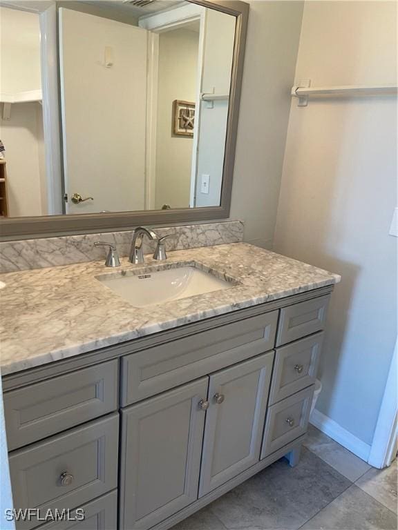 bathroom featuring vanity and baseboards