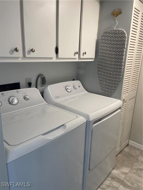 laundry area with cabinet space and washing machine and dryer